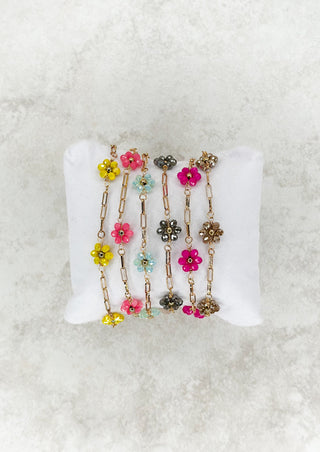 Gold single strand chain bracelet with colored beaded flower.