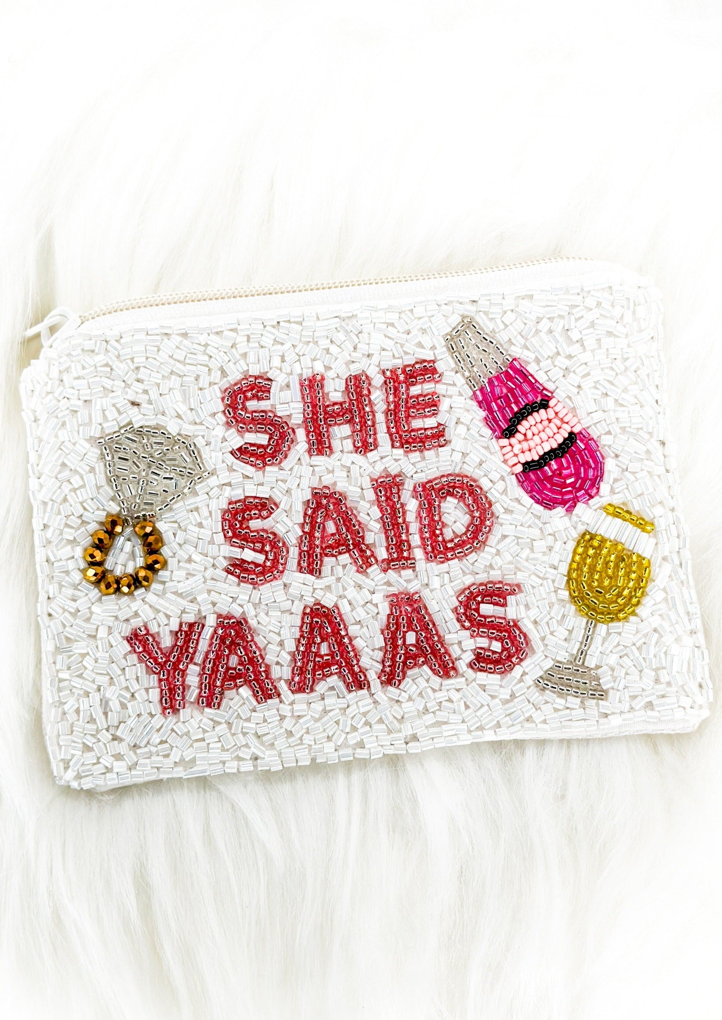 white seed bead coin purse with white zipper - she said yaaas spelled out on one side inn red beads - beaded picture of ring, champagne glass and wine bottle