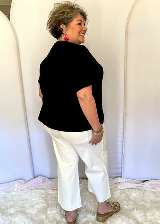 White wide crop Judy Blue jeans with double gold button closure, front patch pockets, high rise fit, and cropped wide leg silhouette with raw hem