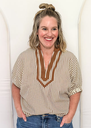 Model wearing the Dolman Striped Brown Top featuring a relaxed fit, classic stripe pattern, and contrasting trim details.