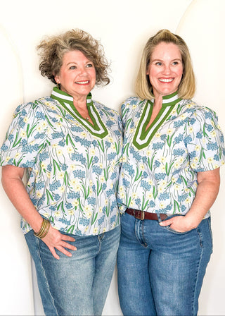 Spring floral top with short sleeves, easy silhouette, and colorful blue and green pattern.