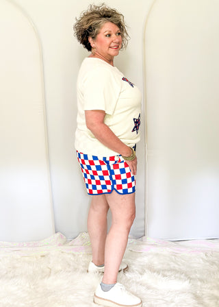 Red, white, and blue checkered shorts with drawstring elastic waist and pockets.