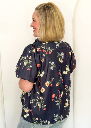 side view of woman in Navy flower blouse