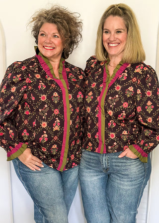 Deep navy floral ruffle trim long sleeve top with rich pink and olive accents.