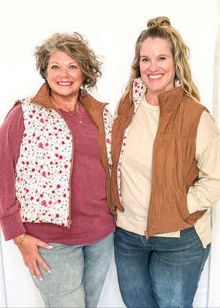 Reversible puffer vest with red and pink floral on one side, brown corduroy on the other.  Pockets on both sides, collared with zipper closure.