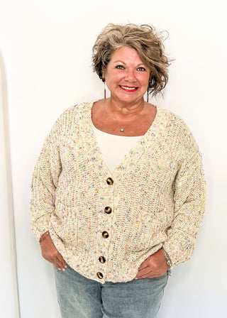 multi fleck of color on this cream button up cardigan.  Oversized fit with two large pockets on the front. 
