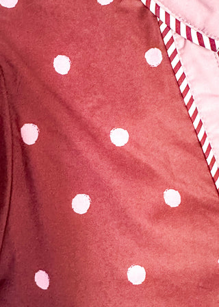 close up of Burgundy polka dot top