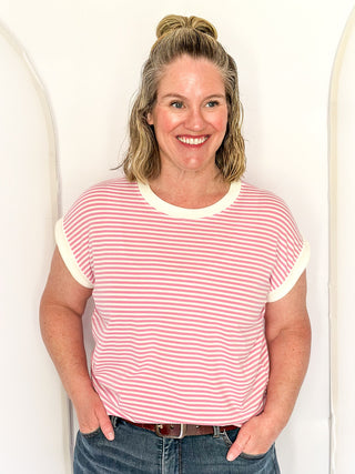 Pink and white stripe short sleeve top with white contrast banding on the collar and sleeves. 