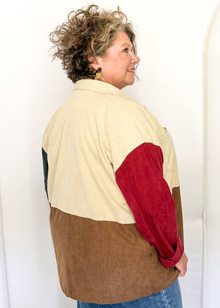Colorblock corduroy shacket with front and side pockets. featuring cream, camel, forest green, and dark red panels, long sleeves, and snap-front closure