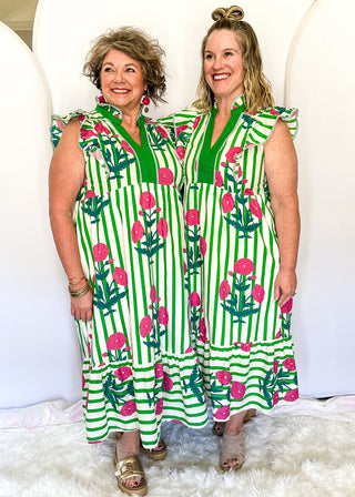 Green and white striped midi dress with pink floral print, flutter sleeves, contrast V-neckline, and a flowy tiered hem