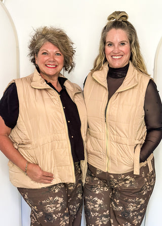 Beige puffer zip up vest with sides that tie and pockets