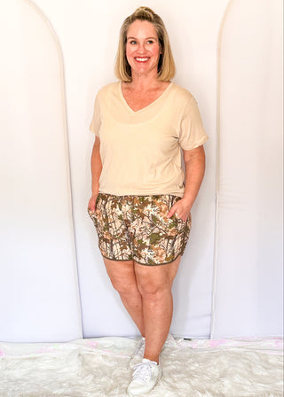 Camo print athletic shorts with dark green trim