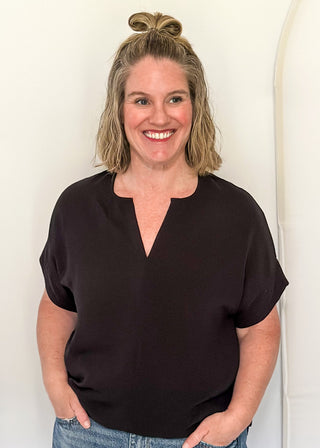 Solid black textured blouse with a V-notch neckline, short sleeves
