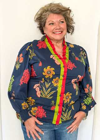 floral long sleeve top with navy background and redish and gold blooms - red and green ruffle around collar and down front - button up