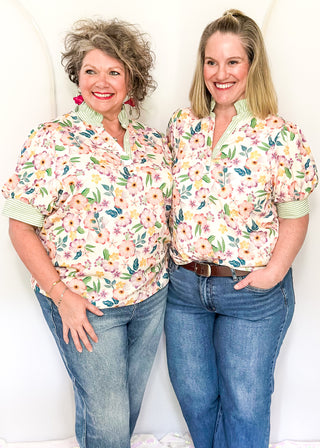 Women’s floral blouse with button front detail and green striped contrast accents