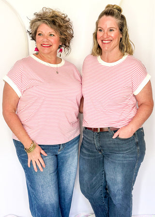 Pink and white stripe short sleeve top with white contrast banding on the collar and sleeves. 