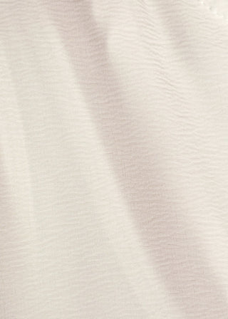 close up of women's ruffle collar blouse with 3/4 sleeve- in off white