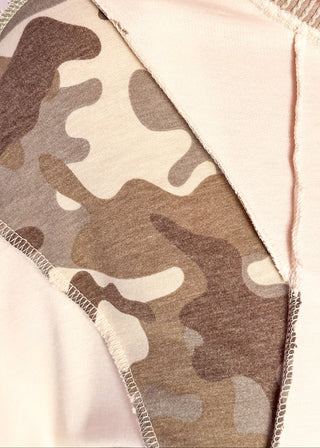 Close up of cream knit colorblock top with camo print shoulder panels, ribbed taupe sleeves and cuffs, and a crew neckline.