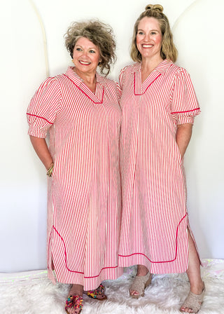 Raspberry and white vertical stripes on a short sleeve v neck midi dress. 