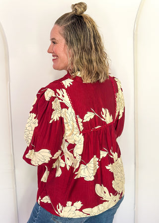 woman in longsleeve burgundy floral top