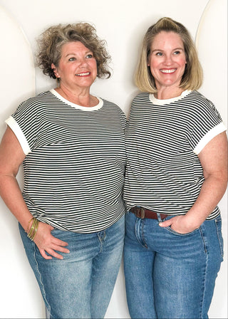 Black and white striped short sleeve top with white banding on sleeve and collar. 