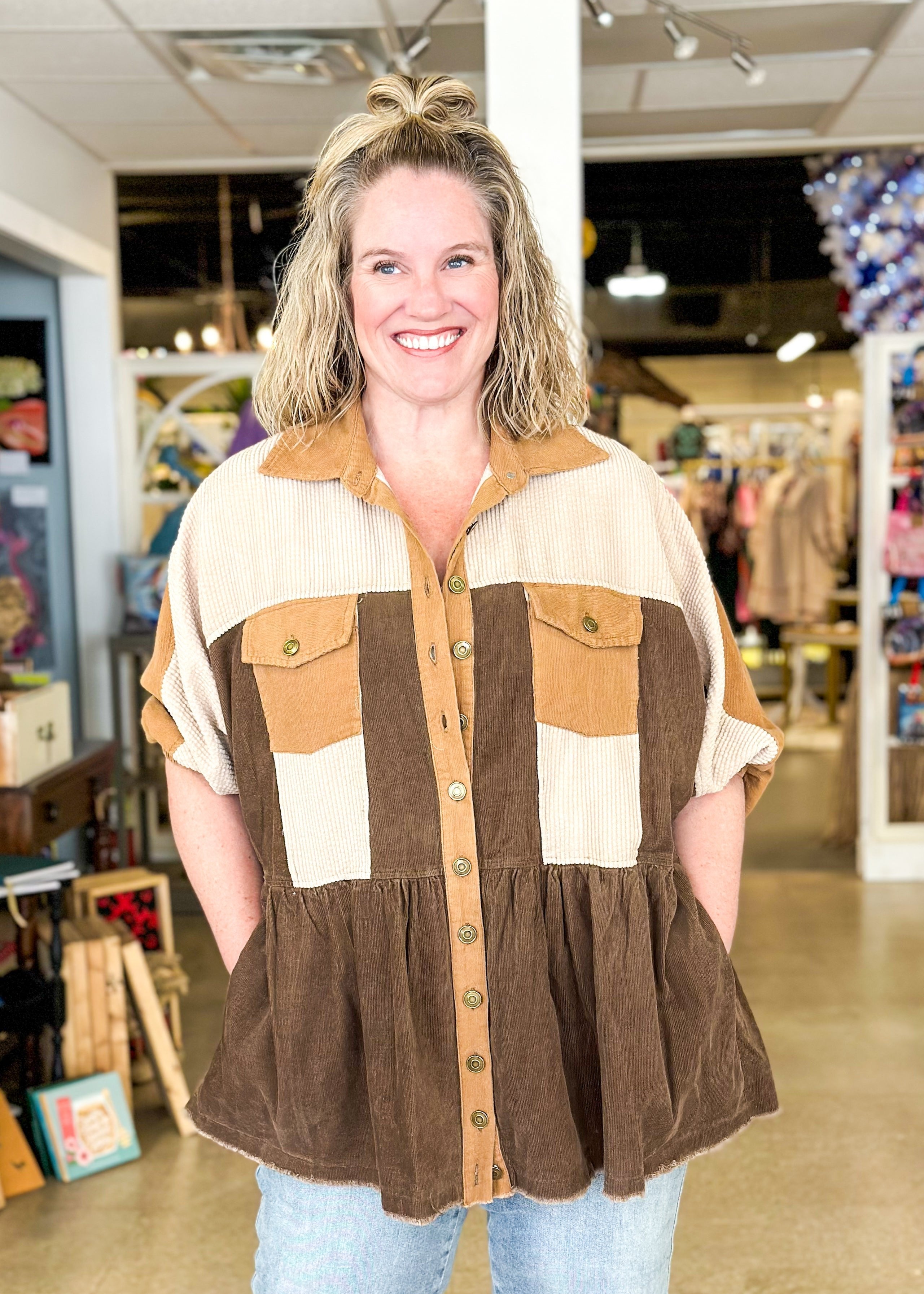 corduroy shacket with functioning buttons down the front and collar, one tier at the bottom, good coverage, shades of brown, sleeve hits at elbow, pockets