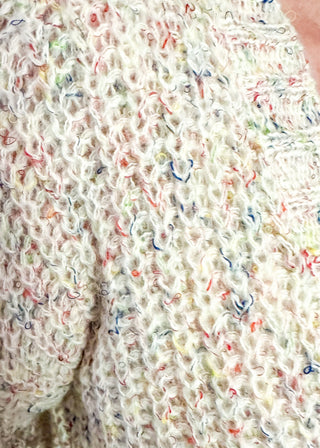 multi fleck of color on this cream button up cardigan.  Oversized fit with two large pockets on the front. 