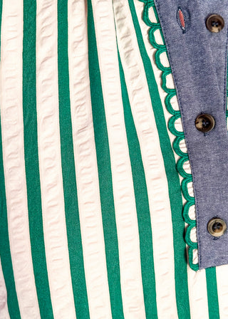 Close up of green striped short sleeve dress with denim contrast on collar and sleeves. 