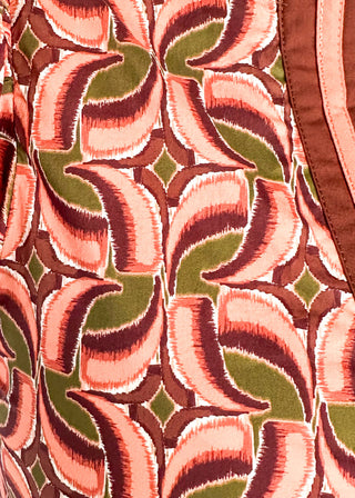 Bubble sleeve V-neck short sleeve top with terracotta, brown and green print. Ribbon detail down the front in brown and terracotta. 
