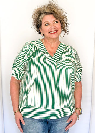 Green striped blouse with lightweight seersucker fabric, short sleeves, and relaxed shape.
