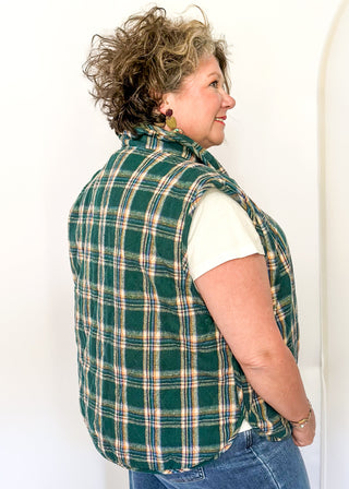 Green plaid puffer vest with snap front and side pockets.