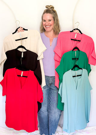 Solid textured blouse with a V-notch neckline, short sleeves in all colorways