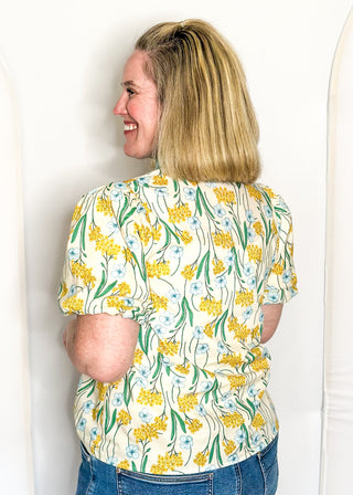 Spring floral top with short sleeves, easy silhouette, and colorful yellow, blue and green.