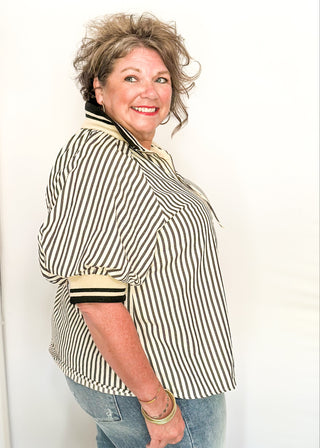 Short sleeve black and off white vertical stripes, zip front collar.  Collar and sleeve has contrast trim with bold stripe