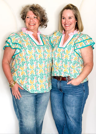 Floral print top with decorative neckline and short ruffle sleeves