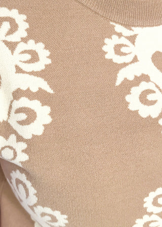 close up of taupe knit sweater with ivory woven pattern and short sleeves.