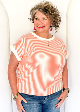 Coral and white stripe short sleeve top with white contrast banding on the collar and sleeves. 