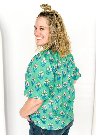 green floral v-neck top with puff short sleeves