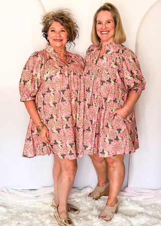 Pink floral short sleeve dress with lined construction, ruffle collar and puff sleeve. 