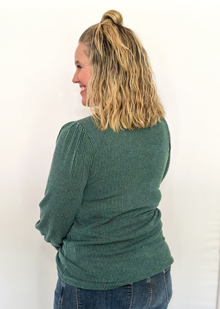 long sleeve ribbed top with cuff sleeve and small puff detail in shoulder. crew neck. 