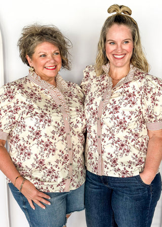 Ivory with small rust colored florals-short sleeve button up top. Rust and ivory stripe ruffle collar and sleeve binding.  