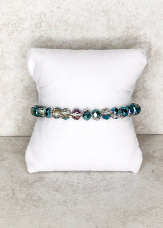 Smoky Teal beaded bracelet displayed on a stand 