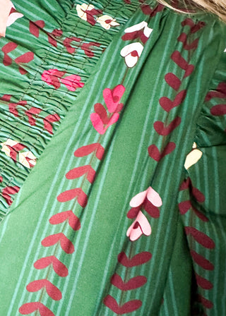 Forest Green Maxi Dress with multi color flower and vine detail throughout.  3/4 length sleeve with smocking around the v-neck, sleeves and waist.  