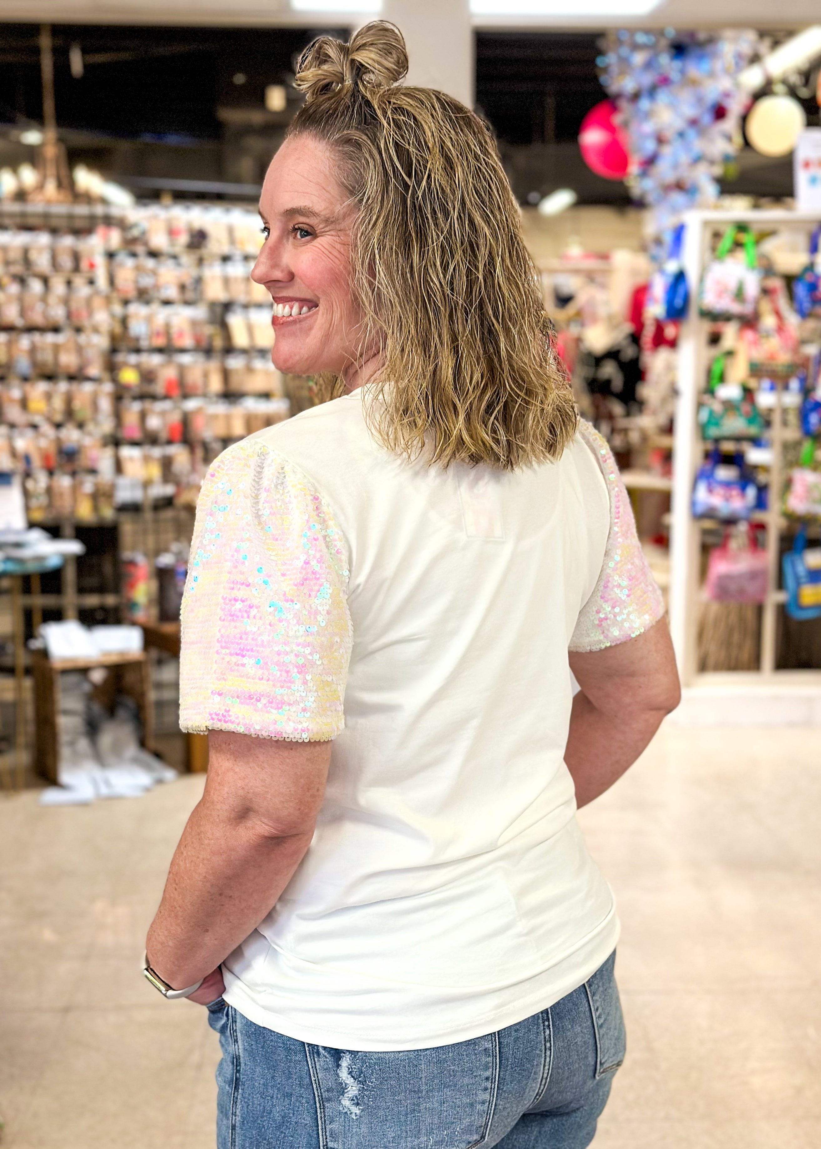 white short sequin sleeve top with XOXO in a light pink on the front - iridescent sequins on sleeves