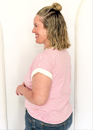 Pink and white stripe short sleeve top with white contrast banding on the collar and sleeves. 