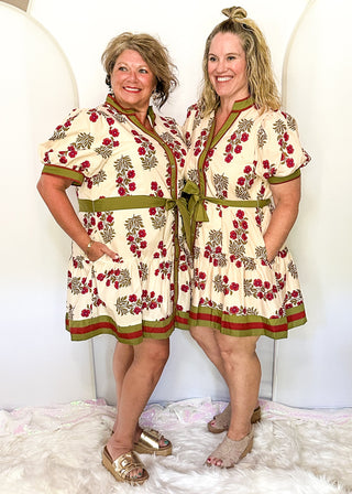 Short sleeve belted dress in ecru with berry florals and contrast piping.  Button up. 