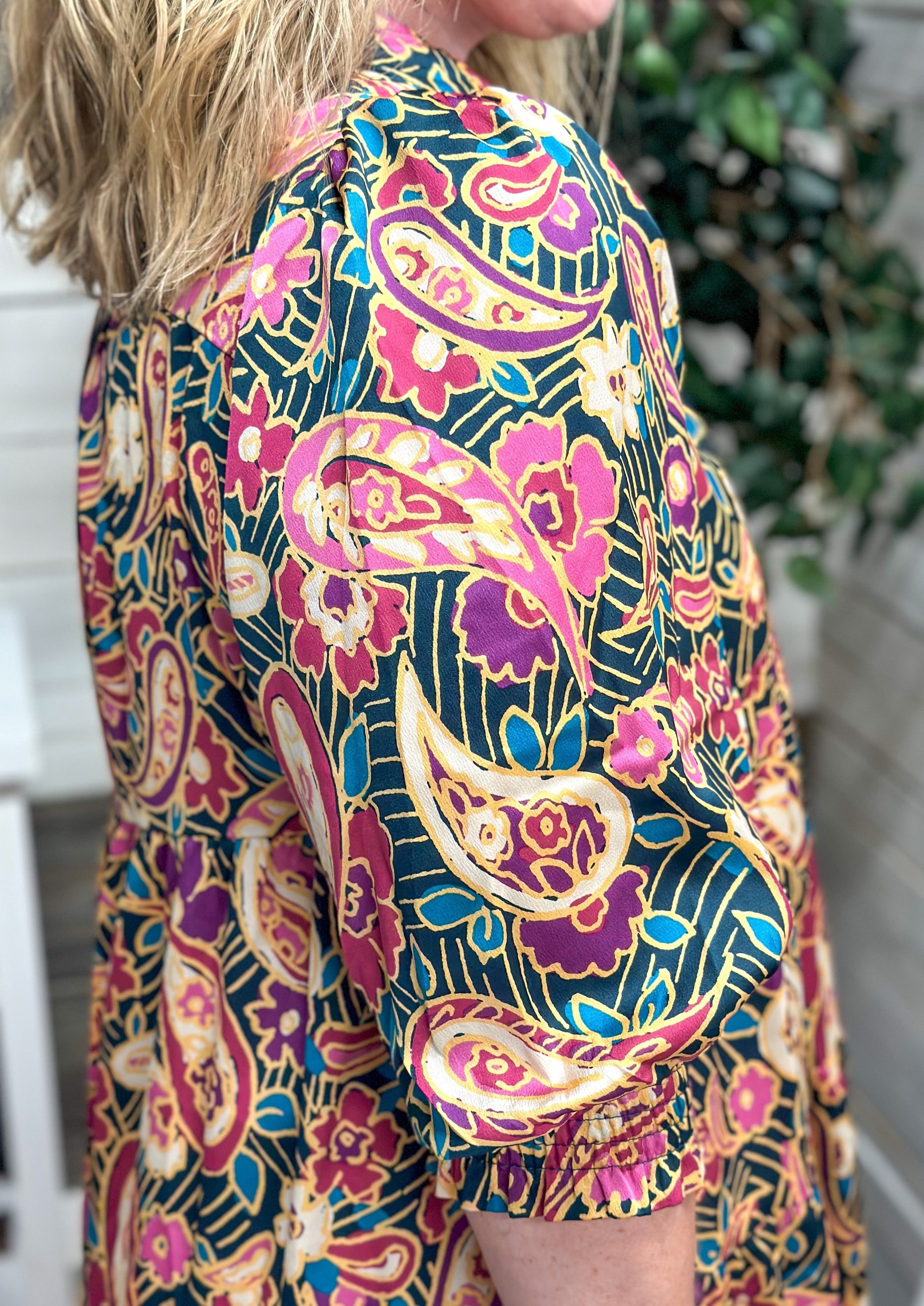 Paisley & Floral Tiered Midi Dress - dark teal/green background - elbow length sleeve with elastic banding - creams/pinks/blues/greans in the floral and paisley design - midi/maxi length - collared neck