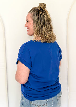 blue short sleeve top with 2 sequin firework bursts.