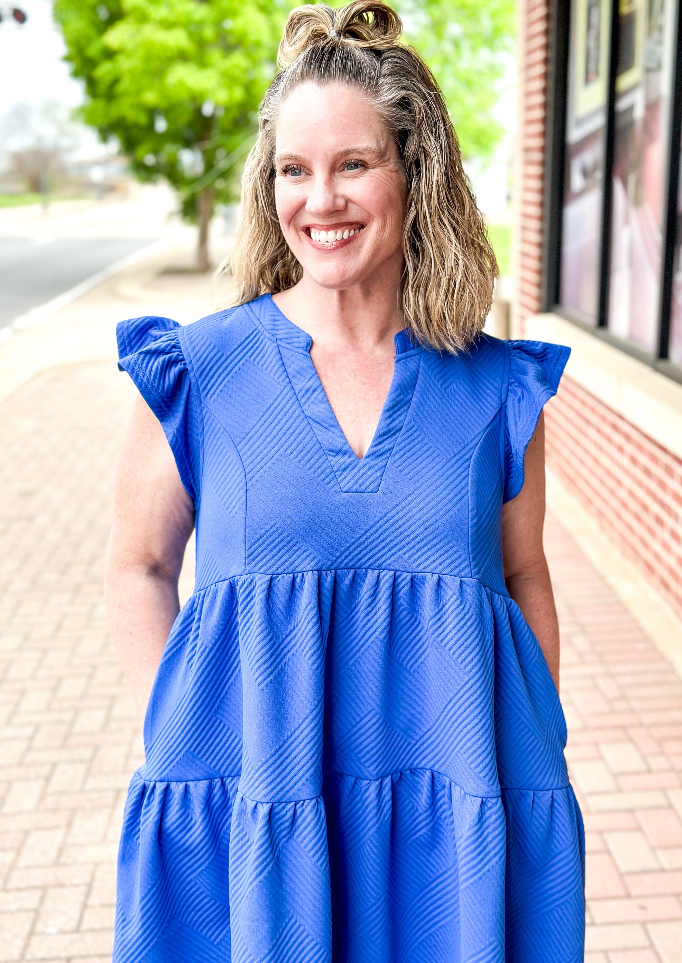 Blue textured tiered dress with ruffle sleeve, pockets, v-neck