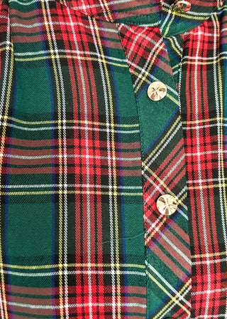 A close-up of a green plaid button-up shirt with red, white, and yellow stripes, featuring gold-toned buttons.